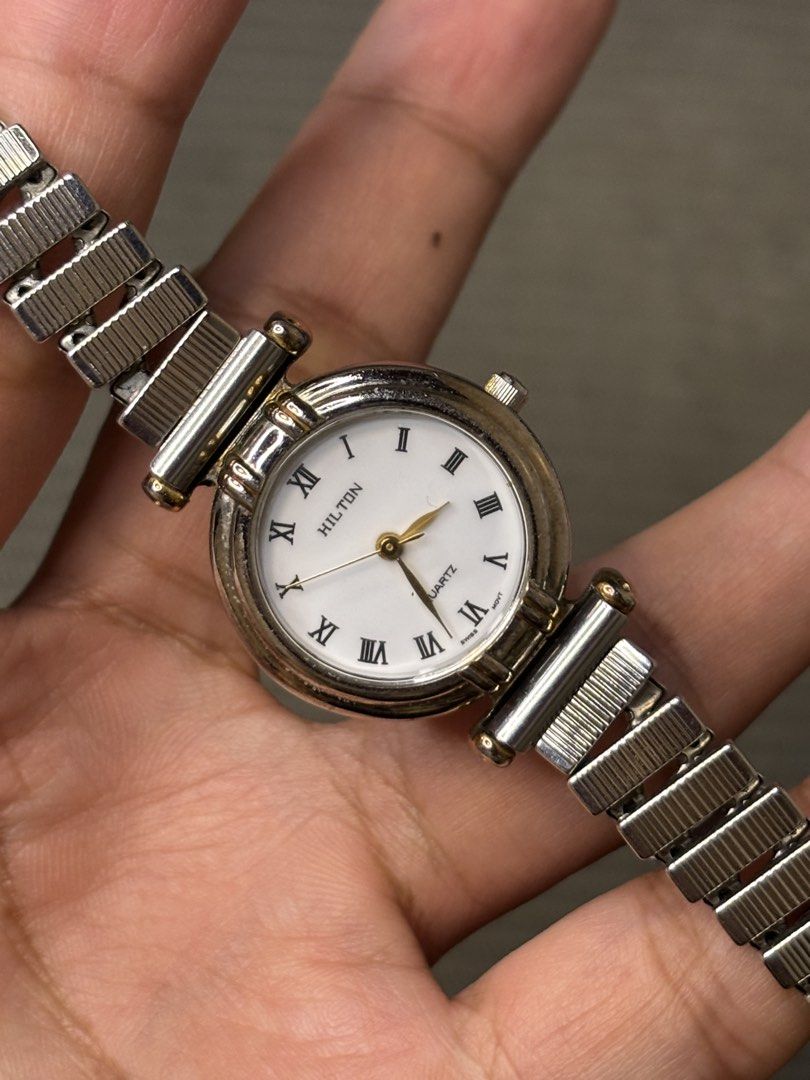 Hilton Ladies Roman Dial (Category: Women's Watches) located in Manila. Submitted by soughtafterseconds (Listing ID 1465750689, Image 2). Description: Hilton Ladies Roman Dial This Hilton Roman Numeral Expansion Bracelet Quartz Watch is a dainty piece of 1980s-to-1990s Swiss-movement dress horology, pairing a clean Roman dial with a classic stretch-link bracelet. Hilton Watch Co. operated as an independent Swiss-American importer and private-labe