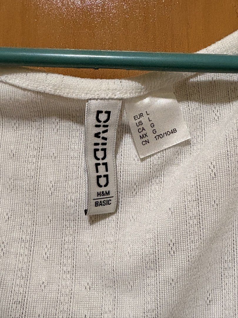 H&M Divided White Ribbed Scoop Neck Top Size L (Category: Shirts) located in Mandaue City. Submitted by klosetfindscebu (Listing ID 1465660837, Image 2). Description: - Brand: H&M Divided - Size: L - Color: White - Style: Short sleeve ribbed top with wide scoop neckline - Material: Textured fabric - Condition: Good basic piece, versatile for everyday wear.