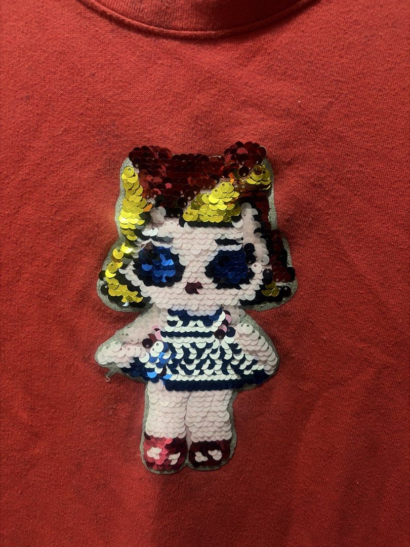 H&M Red Sequined Doll Sweatshirt Size 9-10Y (Category: Babies & Kids Fashion) located in Cainta. Submitted by sarisari_online2020 (Listing ID 1465713173, Image 2). Description: - Brand: H&M - Color: Red - Size: EUR 130 / US 9-10Y - Design: Fun reversible sequin doll graphic on the front - Features: Round neckline, ribbed cuffs, cozy cotton material - Condition: Normal wash wear on fabric, graphics are fully intact - Perfect for: Everyday casual w