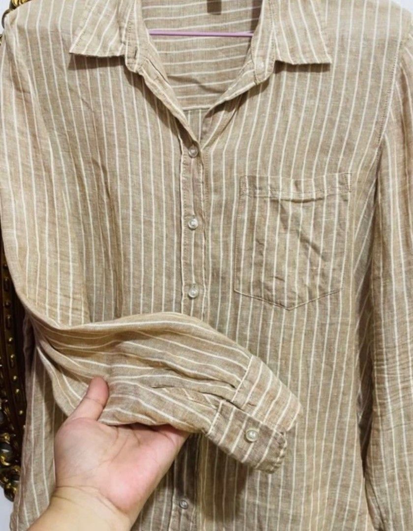 H&M Striped Linen Shirt Size S (Category: Shirts) located in San Juan City. Submitted by marie_d_r (Listing ID 1465685034, Image 3). Description: - Brand: H&M - Color: Neutral brown with white vertical stripes - Size: S - Material: Lightweight, breathable linen fabric - Features: Long sleeves, button-up front, standard collar, single chest pocket - Condition: Excellent / Well-maintained - Perfect for: Casual wear, layering, or warm weather.