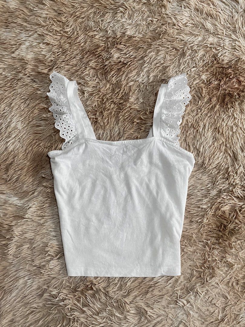 H&M White Eyelet Ruffle Strap Tank Top (Category: Sleeveless) located in Manila. Submitted by stormibutterfly26 (Listing ID 1465654869, Image 1). Description: S-M White H&M tank top.Features cute eyelet ruffle straps and a square neckline. Made of a light, comfortable cotton blend. .