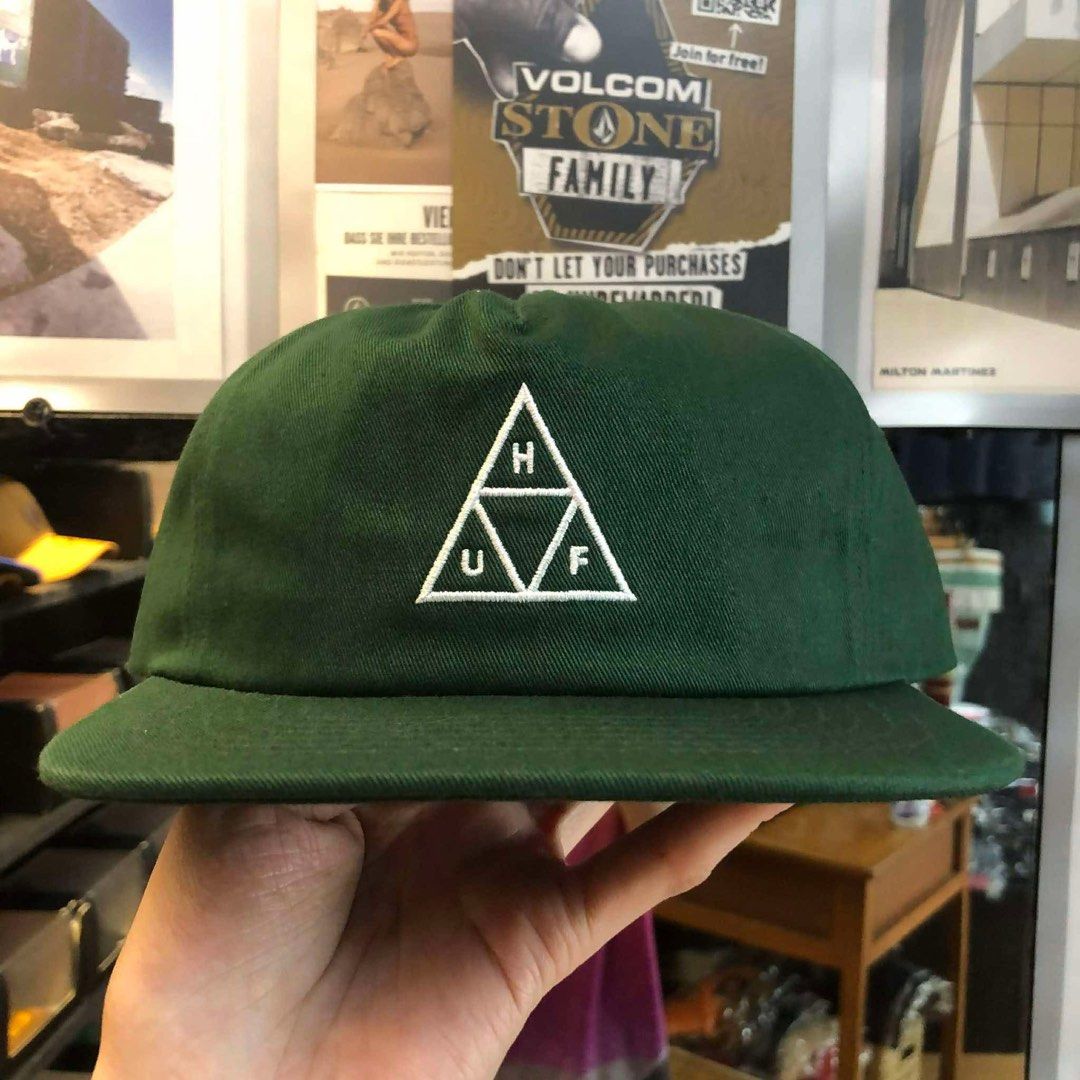 HUF Green Classic H Triple Triangle Snapback Hat (Category: Caps & Hats) located in General Trias. Submitted by km1120 (Listing ID 1465641043, Image 1). Description: - Brand: HUF - Style: Snapback Hat - Color: Dark green with white embroidered triple triangle logo - Material: 100% cotton - Condition: Brand new without tag, never worn, stored in plastic - Features: Adjustable strap at the back, inner tags fully intact.