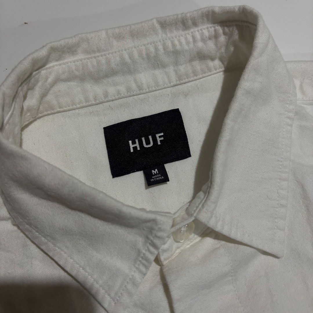 HUF White Short Sleeve Button Up Shirt Medium (Category: Tshirts & Polo Shirts ) located in Cebu City. Submitted by kidfrom6000 (Listing ID 1465751896, Image 3). Description: - Brand: HUF - Style: Short sleeve button-up shirt - Color: White - Size: Medium - Material: Cotton-linen blend - Details: Small embroidered HUF logo on the chest, classic button closure, standard collar - Fit: ~24 inches pit-to-pit - Dimes avail in the pic - cebu city - pri