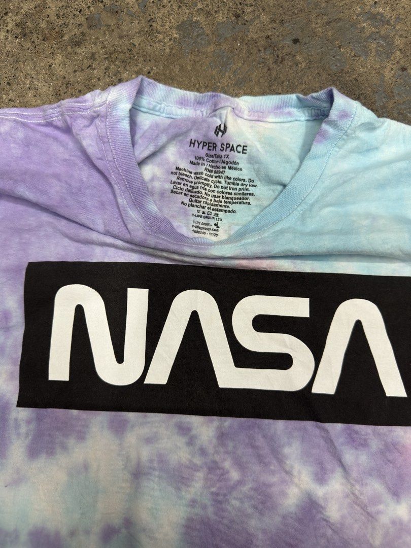 Hyper Space NASA Tie Dye T-Shirt Size 1X (Category: Tshirts & Polo Shirts ) located in Bustos. Submitted by thenlnclot60500 (Listing ID 1465595612, Image 3). Description: - Authentic NASA merchandise - Pastel tie-dye design (purple, blue, and pink) - Classic box logo on front chest - Large 'Explore Space' shuttle graphic on the back - 100% soft and breathable cotton - Size: 1X - Condition: Excellent/New.