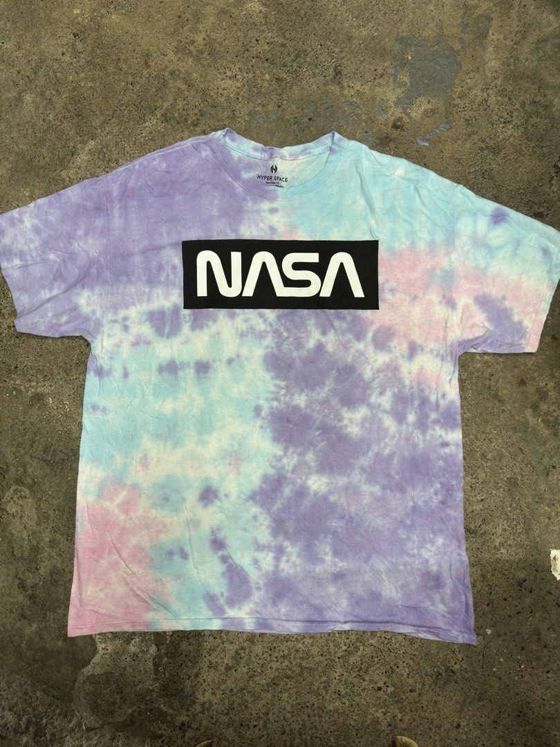 Hyper Space NASA Tie Dye T-Shirt Size 1X (Category: Tshirts & Polo Shirts ) located in Bustos. Submitted by thenlnclot60500 (Listing ID 1465595612, Image 2). Description: - Authentic NASA merchandise - Pastel tie-dye design (purple, blue, and pink) - Classic box logo on front chest - Large 'Explore Space' shuttle graphic on the back - 100% soft and breathable cotton - Size: 1X - Condition: Excellent/New.