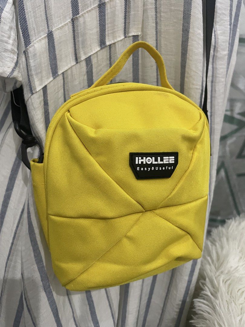 IHOLLEE Mini Backpack Crossbody Bag – Bright Yellow (Category: Belt bags, Clutches and Pouches) located in Cabanatuan. Submitted by moraiahraven (Listing ID 1465753807, Image 2). Description: Cute and practical mini crossbody bag in bright yellow. Features: • Polyester exterior with stylish quilted panel design • Adjustable black shoulder strap (can be worn as crossbody or shoulder bag) • Small yellow top handle for easy grab • Front logo patch: 