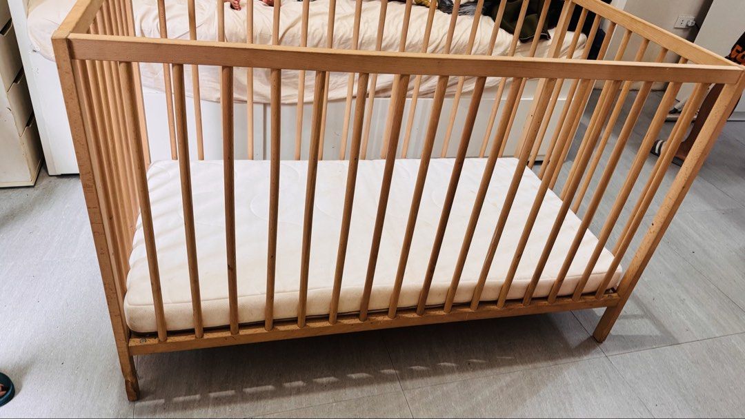 IKEA Beechwood Baby Cot with Mattress (Category: Cots & Cribs) located in Muntinlupa City. Submitted by joanmarcos (Listing ID 1465678406, Image 3). Description: - Solid beech wood baby cot frame with damage on one leg (from dog bite) but still sturdy - Slatted design on all sides for optimal airflow - Sturdy four-leg construction - Standard rectangular size, great for nurseries and toddlers - Includes fitted white mattress (note: has light stain