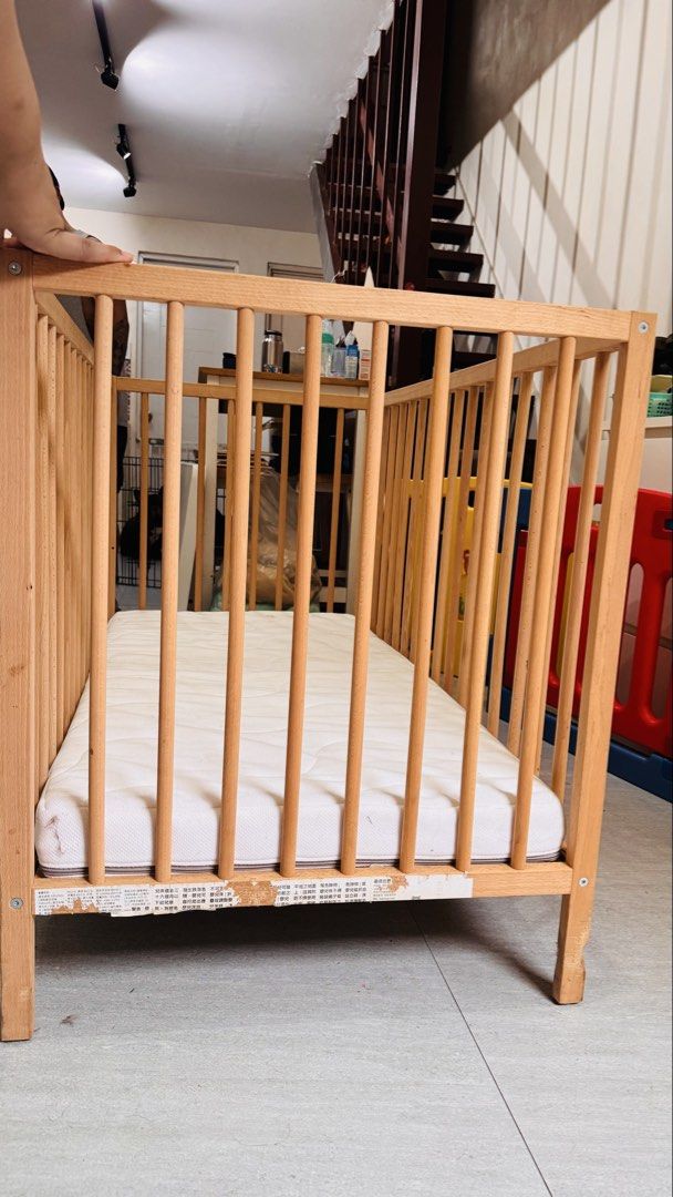 IKEA Beechwood Baby Cot with Mattress (Category: Cots & Cribs) located in Muntinlupa City. Submitted by joanmarcos (Listing ID 1465678406, Image 2). Description: - Solid beech wood baby cot frame with damage on one leg (from dog bite) but still sturdy - Slatted design on all sides for optimal airflow - Sturdy four-leg construction - Standard rectangular size, great for nurseries and toddlers - Includes fitted white mattress (note: has light stain