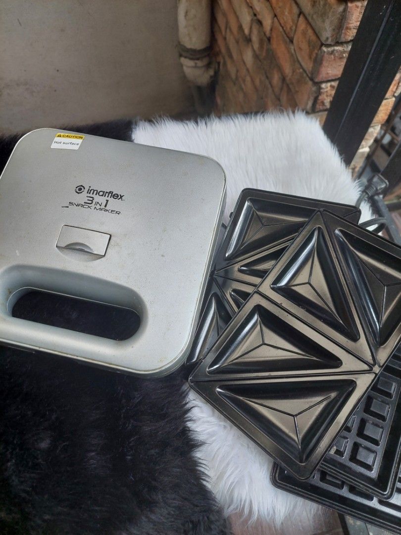 Imarflex 3 in 1 Snack Maker (Category: Cookware & Accessories) located in Navotas City. Submitted by venizianess (Listing ID 1465703367, Image 3). Description: - Brand/Model: Imarflex 3-in-1 Snack Maker (Silver & Black) - Includes 3 sets of interchangeable non-stick plates (Sandwich, Grill, Waffle) - Compact countertop design saves kitchen space - Convenient indicator lights on the handle for power status - Easy to swap plates for quick breakfast