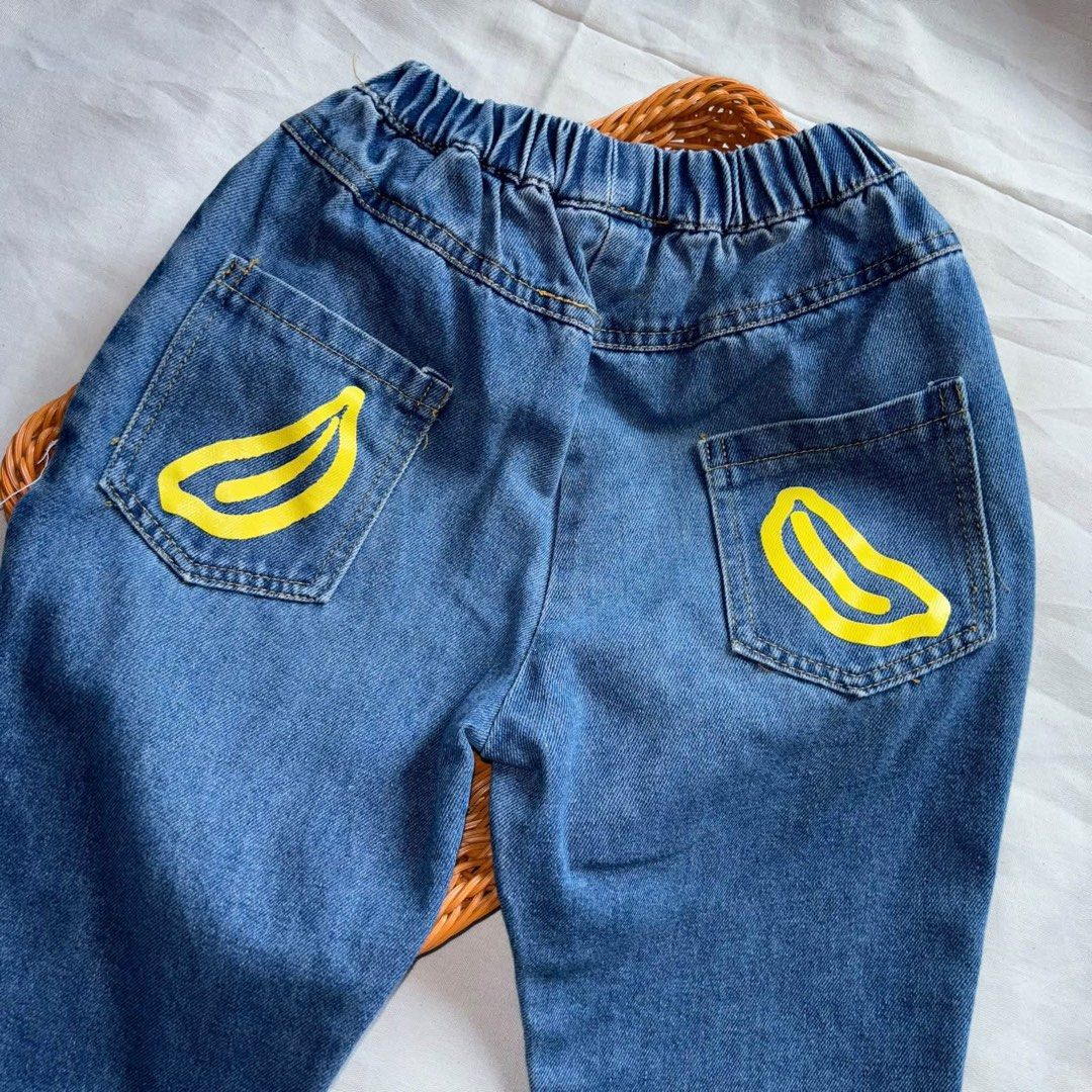 Inspired Bape Size 110 2-3yrs old Jeans (Category: Babies & Kids Fashion) located in Manila. Submitted by miamoire (Listing ID 1465579461, Image 2). Description: - Style: Inspired Bape kids denim pants - Size: 110 (fits ages 2 to 3 years old) - Comfort: Elastic waistband and cuffs at the ankles for an easy fit - Details: White graphic print on the front left leg - Pockets: Two back pockets featuring fun yellow banana graphics - Color: Classic blu