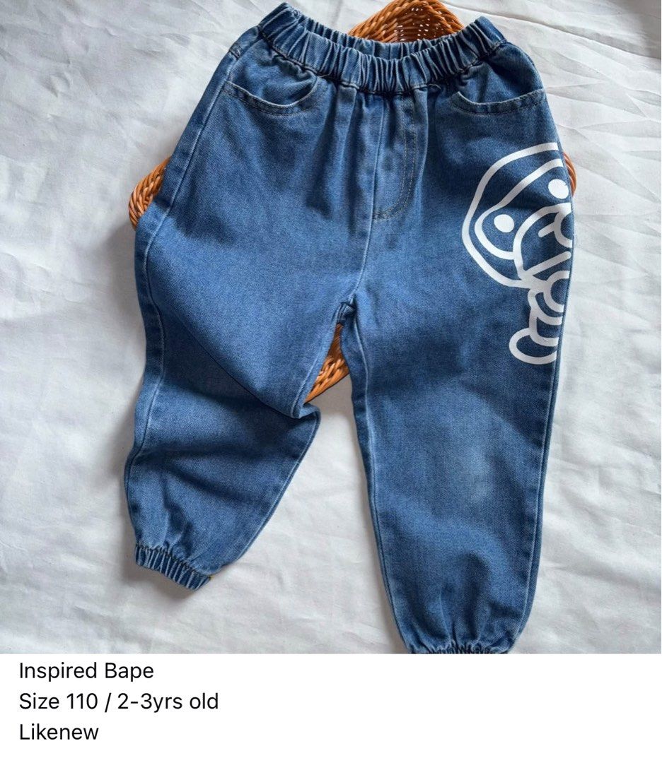 Inspired Bape Size 110 2-3yrs old Jeans (Category: Babies & Kids Fashion) located in Manila. Submitted by miamoire (Listing ID 1465579461, Image 1). Description: - Style: Inspired Bape kids denim pants - Size: 110 (fits ages 2 to 3 years old) - Comfort: Elastic waistband and cuffs at the ankles for an easy fit - Details: White graphic print on the front left leg - Pockets: Two back pockets featuring fun yellow banana graphics - Color: Classic blu