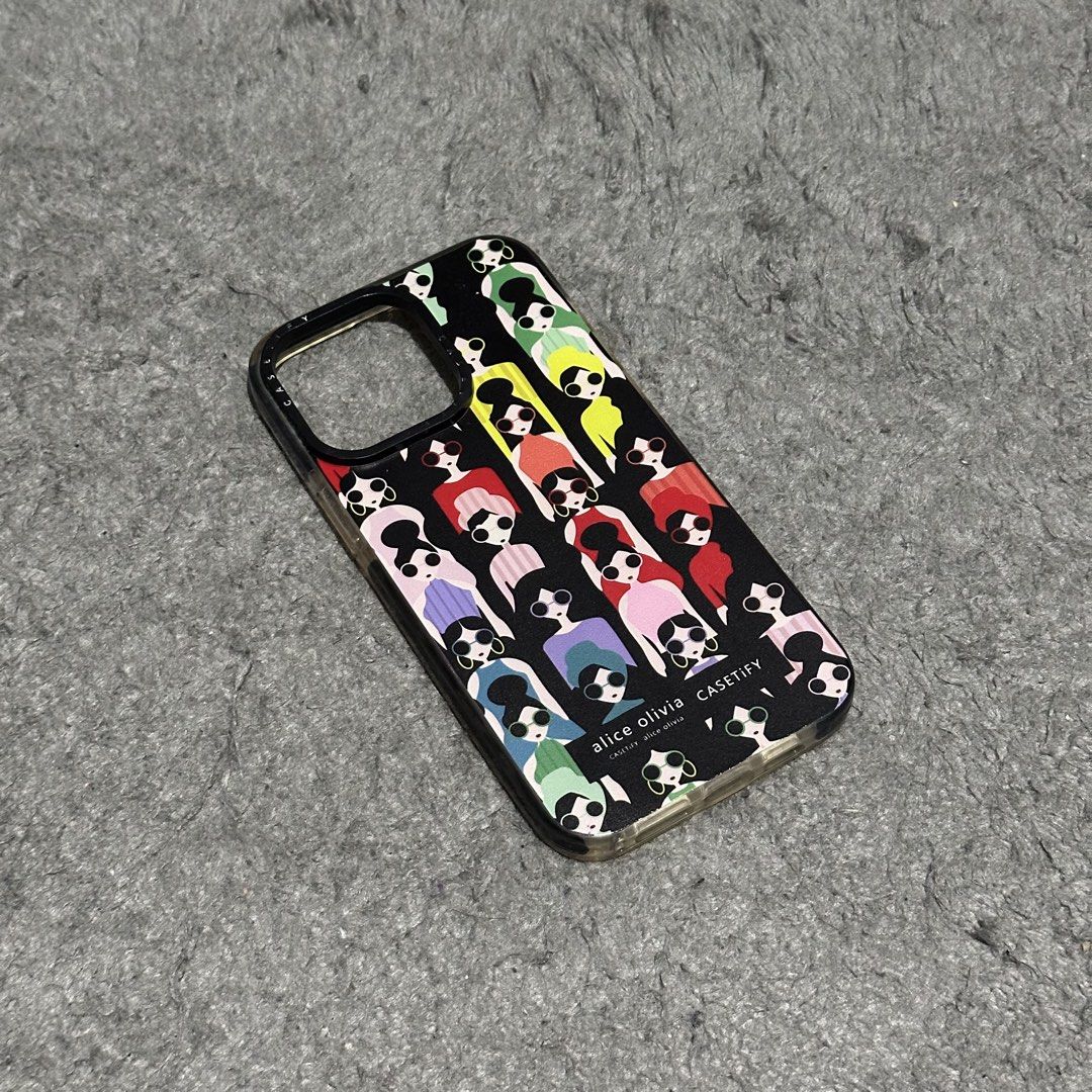 Iphone 14 Pro Max Phone Case (Category: Cases & Sleeves) located in Lipa City. Submitted by jecoparra (Listing ID 1465699516, Image 2). Description: - Model: iPhone 14 Pro Max Phone Case - Design: Trendy Alice + Olivia colorful character graphic on black background - Condition: Layered condition 7/10, well-maintained - Fit: Perfect and secure fit for the specified phone model - Style: Fashionable, eye-catching, and durable everyday protection.