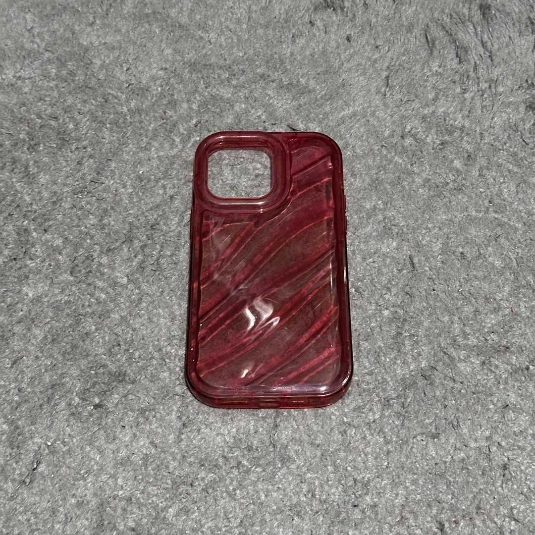 Iphone 14 Pro Max Phone Case (Category: Cases & Sleeves) located in Lipa City. Submitted by jecoparra (Listing ID 1465700047, Image 1). Description: - Compatible Model: iPhone 14 Pro Max - Color: Vibrant Red - Design: Translucent with diagonal striped texture - Condition: Excellent, well-maintained - Protection: Durable shell to keep your phone safe from scratches.