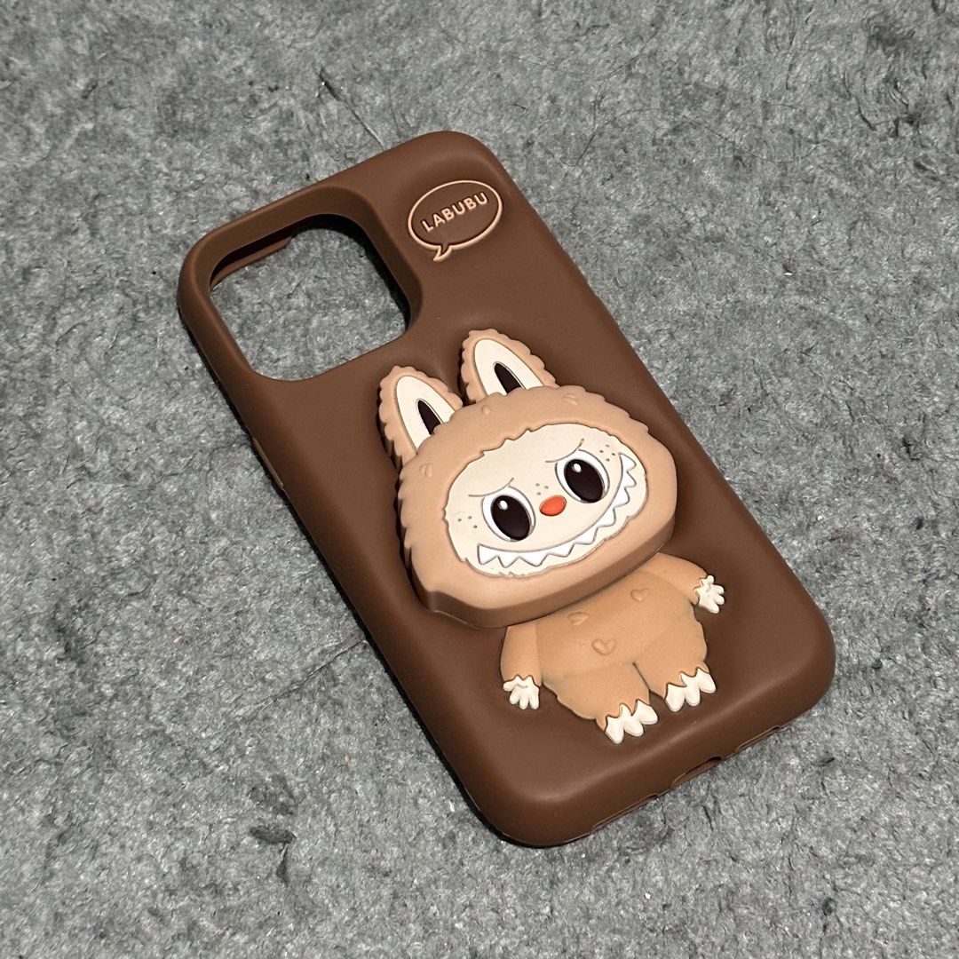 Iphone 14 Pro Max Phone Case (Category: Cases & Sleeves) located in Lipa City. Submitted by jecoparra (Listing ID 1465702315, Image 2). Description: - Compatible Model: iPhone 14 Pro Max - Color: Brown - Material: High-quality flexible silicone - Design: Cute 3D embossed Labubu monster character with text detail - Condition: Excellent / gently used - Features: Provides daily protection, anti-slip texture, and unique playful aesthetic.