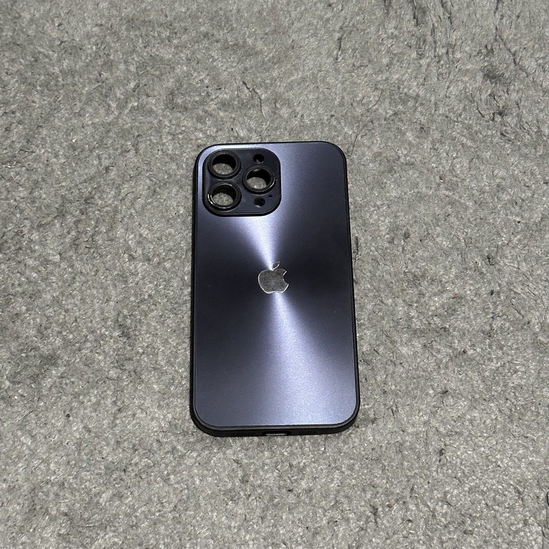 Iphone 15 Pro Max Phone Case (Category: Cases & Sleeves) located in Lipa City. Submitted by jecoparra (Listing ID 1465703011, Image 1). Description: - Compatible Model: iPhone 15 Pro Max - Color: Metallic dark grey/purple gradient with sleek sunburst aesthetic - Camera Protection: Integrated raised rings for triple camera lens safety - Interior: Textured shock-absorbing pattern for better grip and protection - Condition: 7/10, well-maintained and