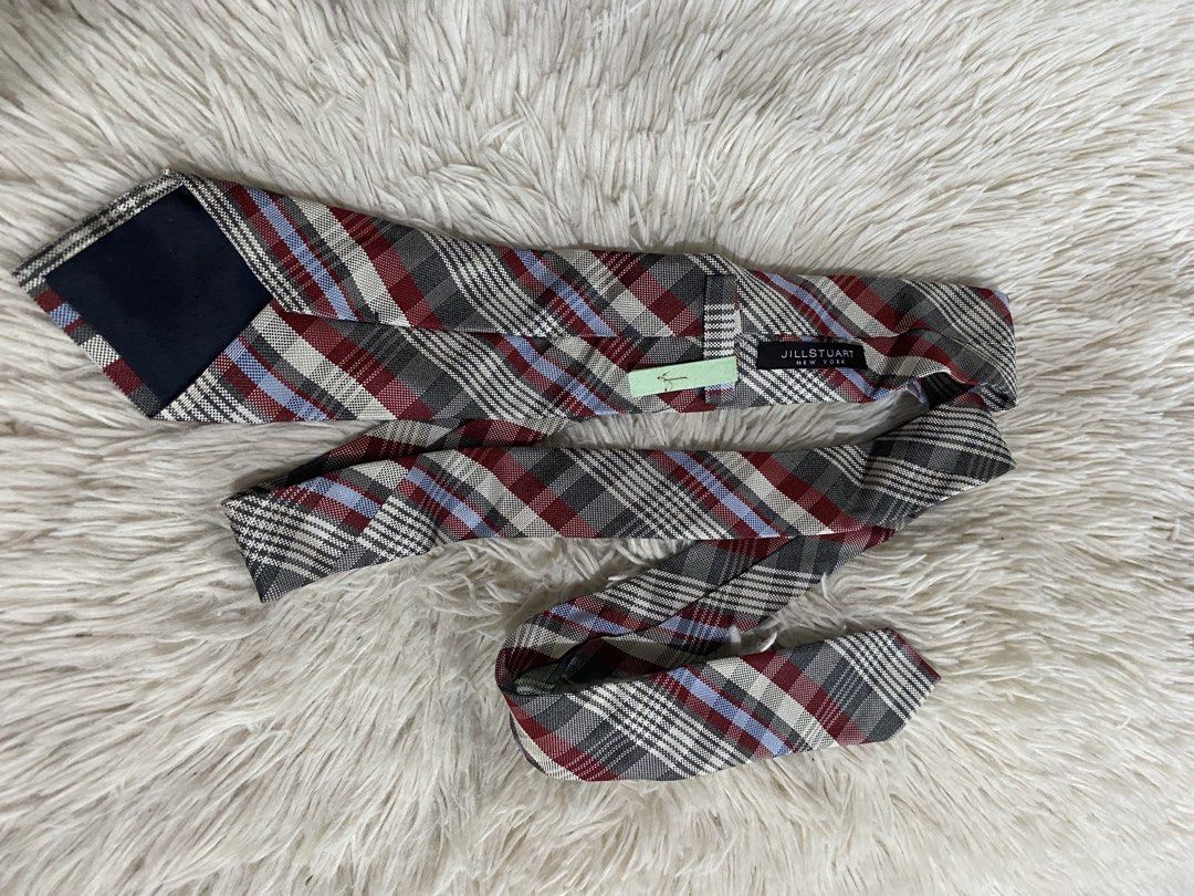 Jill Stuart New York Plaid Necktie (Category: Ties) located in Bulacan. Submitted by rich2545 (Listing ID 1465581492, Image 2). Description: - Brand: Jill Stuart New York - Design: Classic plaid pattern with grey, burgundy, white, and light blue stripes - Condition: Brand new with tag attached, very clean - Features: Secure fabric keeper loop and stitched brand label on the back - Versatility: Ideal for work, formal events, and smart casual outfi