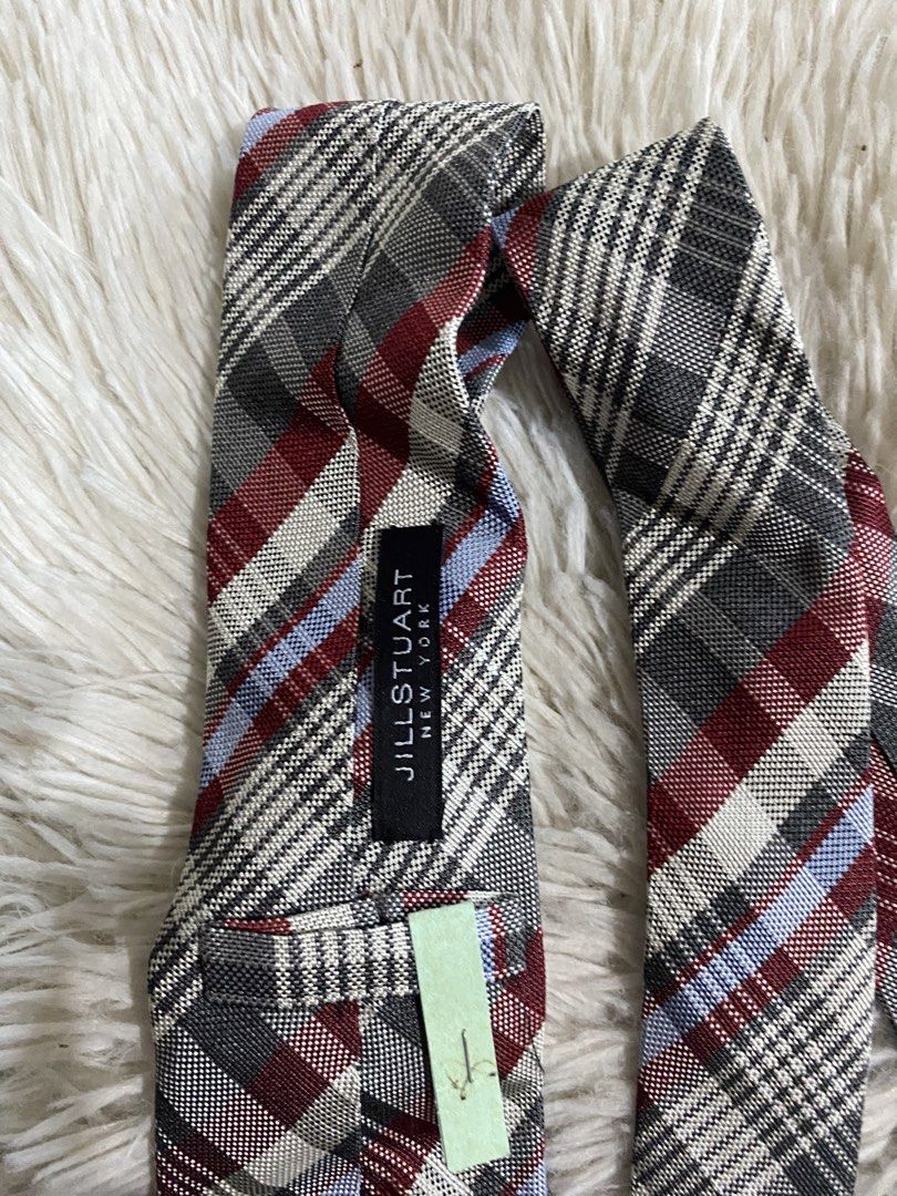 Jill Stuart New York Plaid Necktie (Category: Ties) located in Bulacan. Submitted by rich2545 (Listing ID 1465581492, Image 3). Description: - Brand: Jill Stuart New York - Design: Classic plaid pattern with grey, burgundy, white, and light blue stripes - Condition: Brand new with tag attached, very clean - Features: Secure fabric keeper loop and stitched brand label on the back - Versatility: Ideal for work, formal events, and smart casual outfi