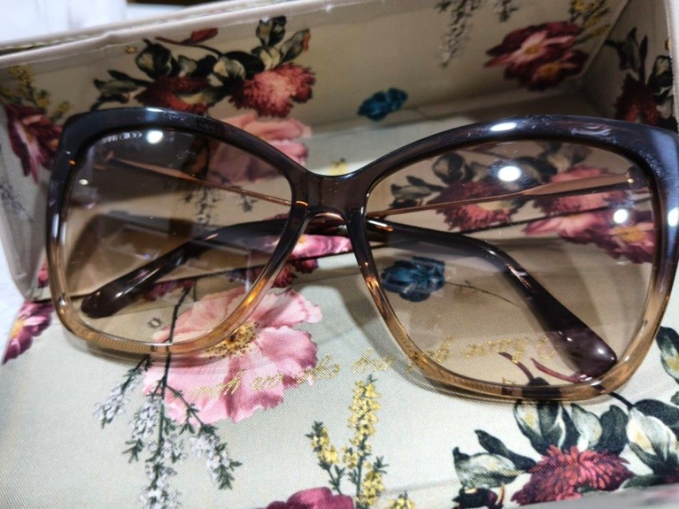 Jimmy Choo gradient brown sunglasses with crystal temples (Category: Sunglasses & Eyewear) located in Tarlac. Submitted by momma02 (Listing ID 1465579765, Image 2). Description: - Authentic Jimmy Choo designer sunglasses - Frame: Tortoise-style with slender gold-tone metal arms - Lenses: Gradient brown, pristine condition with no scratches - Details: Brand name engraved near the hinge and a small square crystal embellishment at the corner - Condi