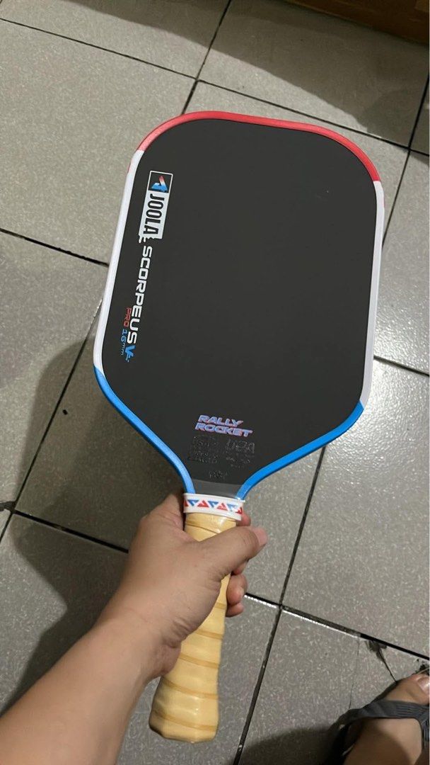 Joola Hyperion Pro 16mm Pickleball Paddle (Category: Racket and Ball Sports) located in Quezon City. Submitted by pickleballpaddle (Listing ID 1465623378, Image 2). Description: - Brand: Joola Hyperion Pro 16mm Pickleball Paddle - Condition: Brand new, never used on court, pristine condition - Face: Standard shape with textured surface for enhanced spin control - Handle: Still wrapped in original protective plastic film - Warranty: QR code sticke
