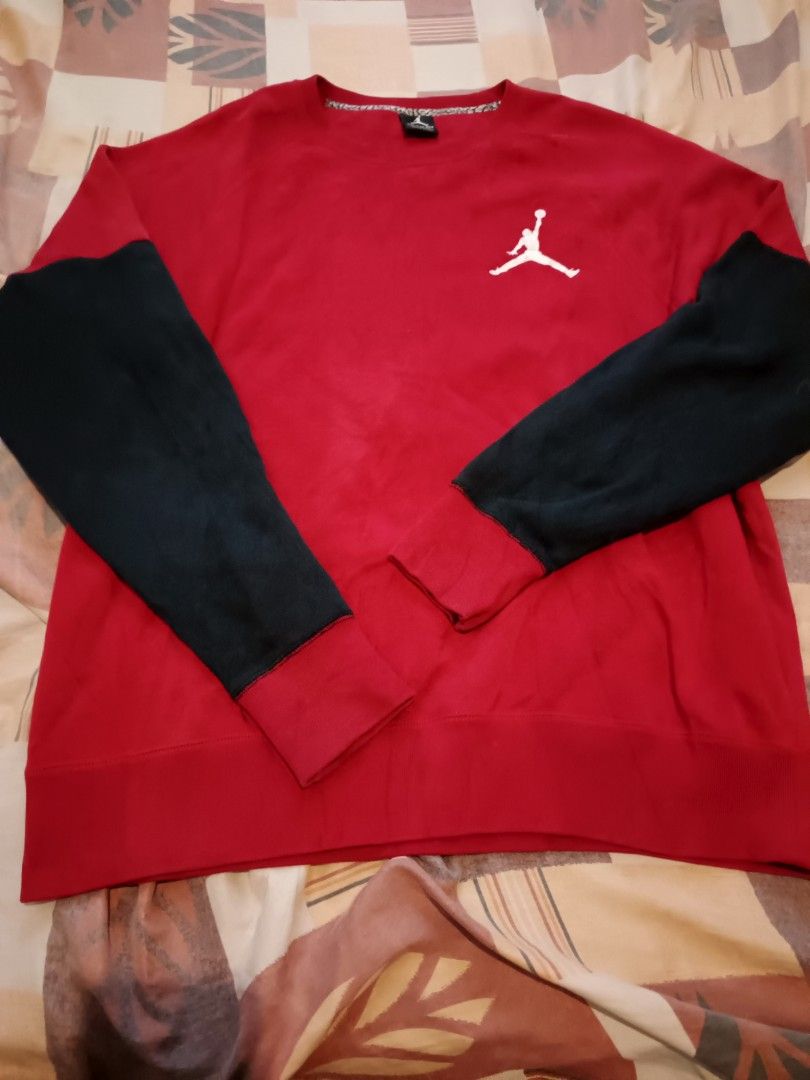 Jordan crewneck sweetshirt (Category: Activewear) located in Odiongan. Submitted by thriftngo26 (Listing ID 1465599311, Image 2). Description: The image shows a red and black Air Jordan Varsity Crewneck Sweatshirt featuring a white Jumpman logo on the upper left chest and contrasting black sleeves..