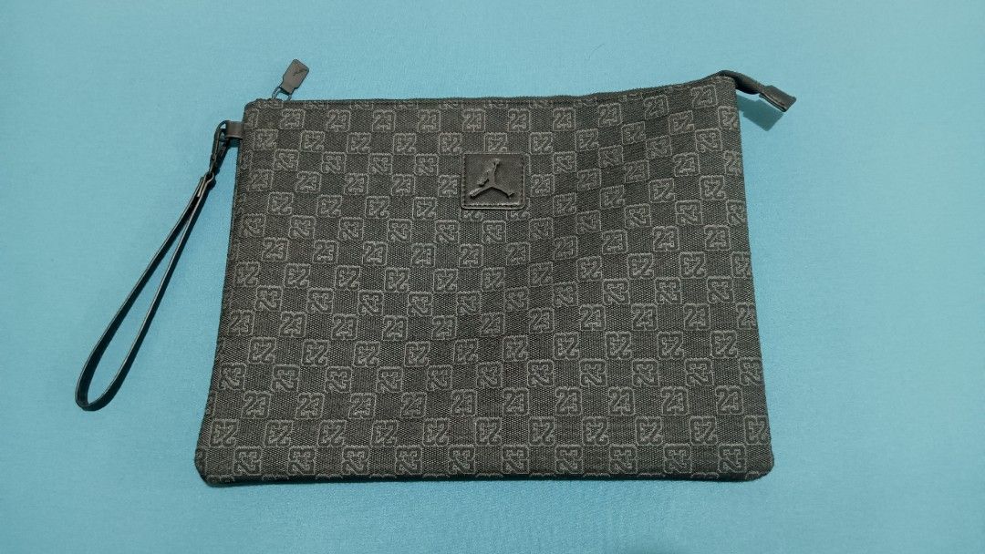 Jordan Monogram Clutch Pouch Large (Category: Belt bags, Clutches and Pouches) located in Quezon City. Submitted by baxt3r (Listing ID 1465702722, Image 1). Description: - Authentic Jordan monogram pouch in sleek black and grey - Features all-over '23' pattern with stitched Jumpman logo patch - Convenient zip top closure and attached wrist strap - Clean interior lining with 100% polyester material - Great size for organizing and carrying daily es