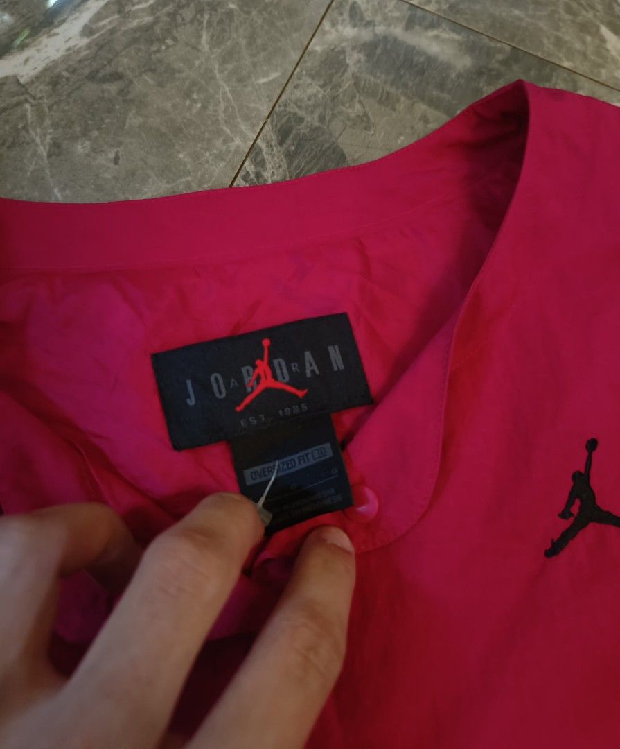 Jordan Pink Oversized Fit Jacket (Category: Coats, Jackets and Outerwear) located in Alaminos. Submitted by christianberbo (Listing ID 1465617614, Image 2). Description: - Brand: Jordan - Color: Bright Pink with Black Jumpman logo - Fit: Oversized style - Material: Lightweight nylon and polyester - Closure: Snap button front - Pockets: Large round pockets on both sides - Condition: Brand new / excellent - Mode of payment: GCash, - Shipping: Same 