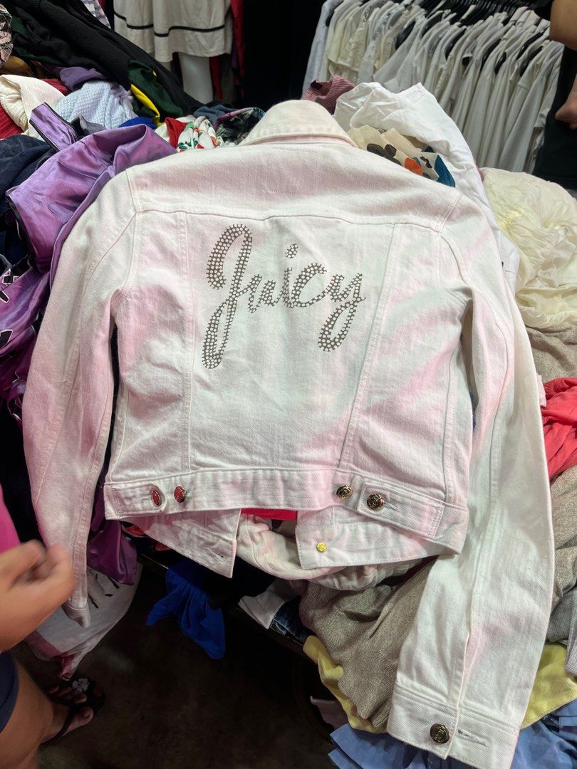 Juicy Couture White Denim Jacket with Rhinestone Logo (Category: Coats, Jackets and Outerwear) located in Caloocan City. Submitted by pumarenluc79160 (Listing ID 1465719455, Image 1). Description: - Brand: Juicy Couture - Size: XS - Color: White - Details: Gold rhinestone buttons on front and cuffs - Back: Eye-catching rhinestone 'Juicy' logo - Pockets: Two button-flap chest pockets - Fit: Classic cropped denim jacket style, ideal for layering - 