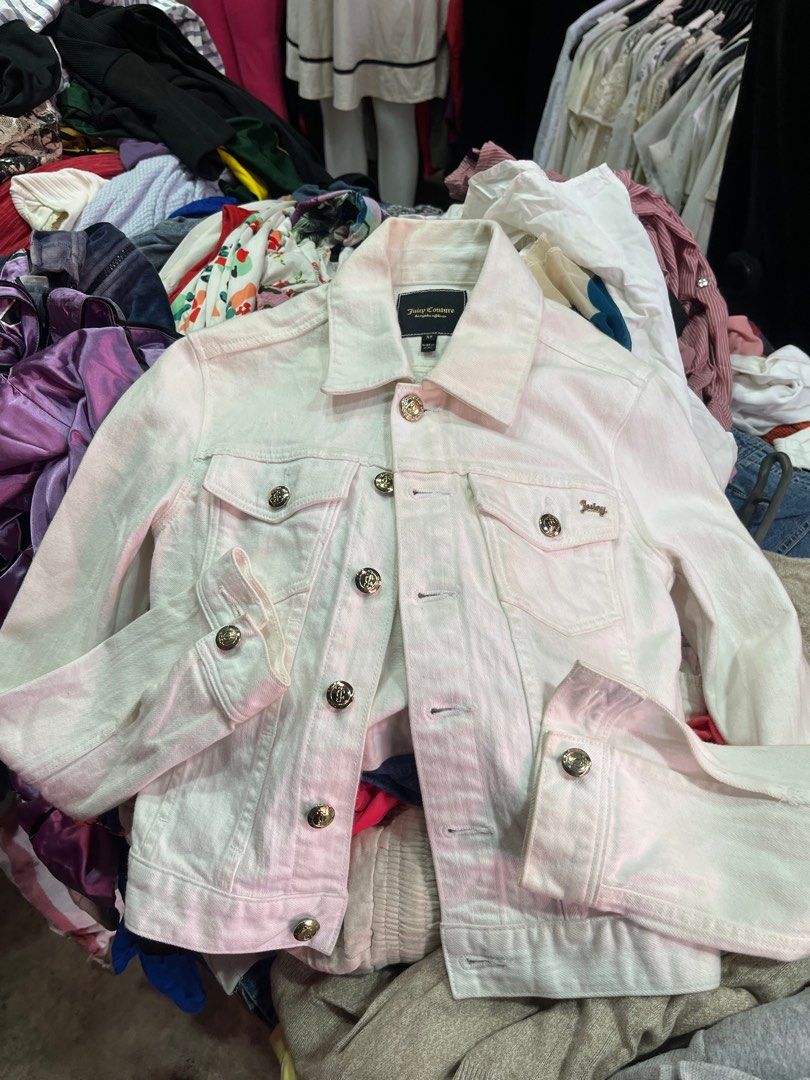 Juicy Couture White Denim Jacket with Rhinestone Logo (Category: Coats, Jackets and Outerwear) located in Caloocan City. Submitted by pumarenluc79160 (Listing ID 1465719455, Image 2). Description: - Brand: Juicy Couture - Size: XS - Color: White - Details: Gold rhinestone buttons on front and cuffs - Back: Eye-catching rhinestone 'Juicy' logo - Pockets: Two button-flap chest pockets - Fit: Classic cropped denim jacket style, ideal for layering - 