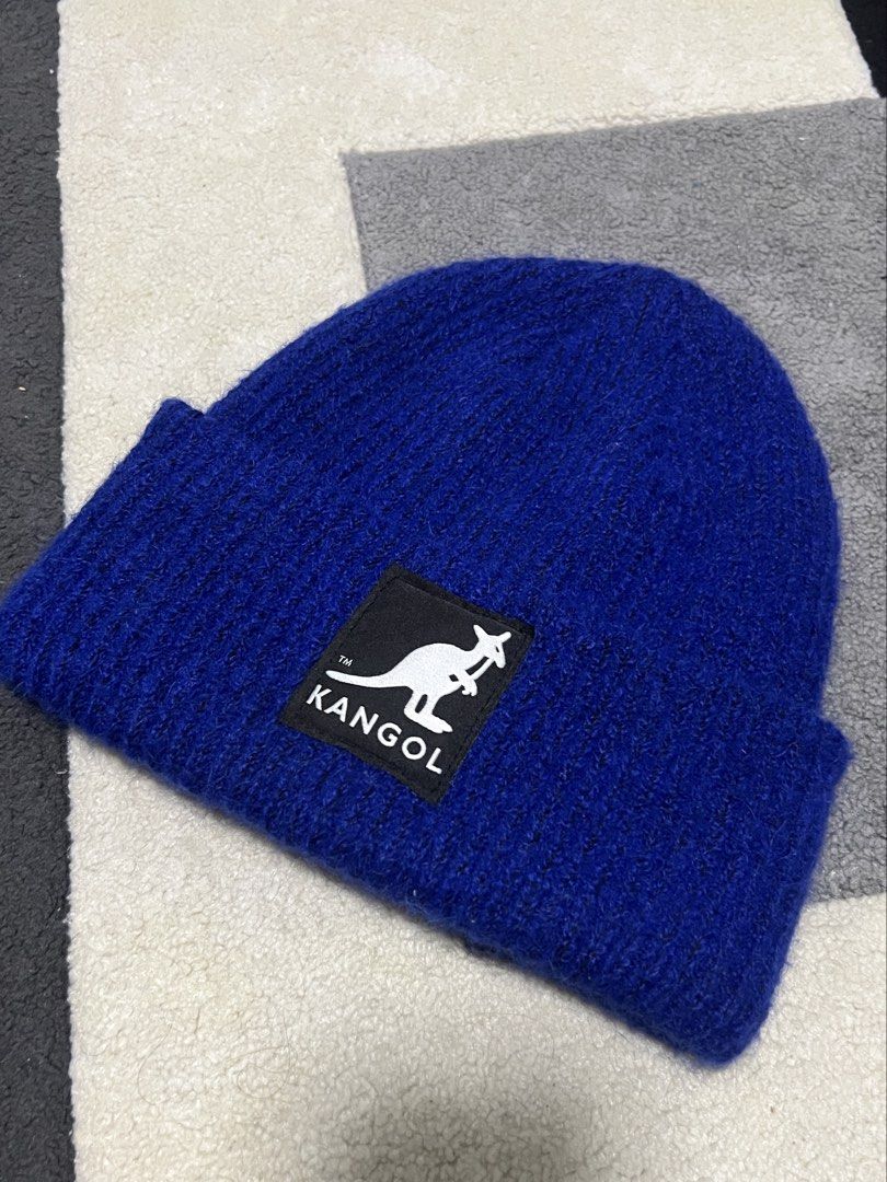 Kang x H&M Blue Beanie (Category: Hats & Beanies) located in Calasiao. Submitted by pb.supply_v2 (Listing ID 1465752785, Image 2). Description: - Brand: Kangol x H&M - Color: Bright blue - Design: Classic folded cuff with embroidered kangaroo logo patch - Material: Soft and fuzzy yarn for extra warmth - Size: One size fits most adults - Style: Perfect for streetwear and casual everyday wear.