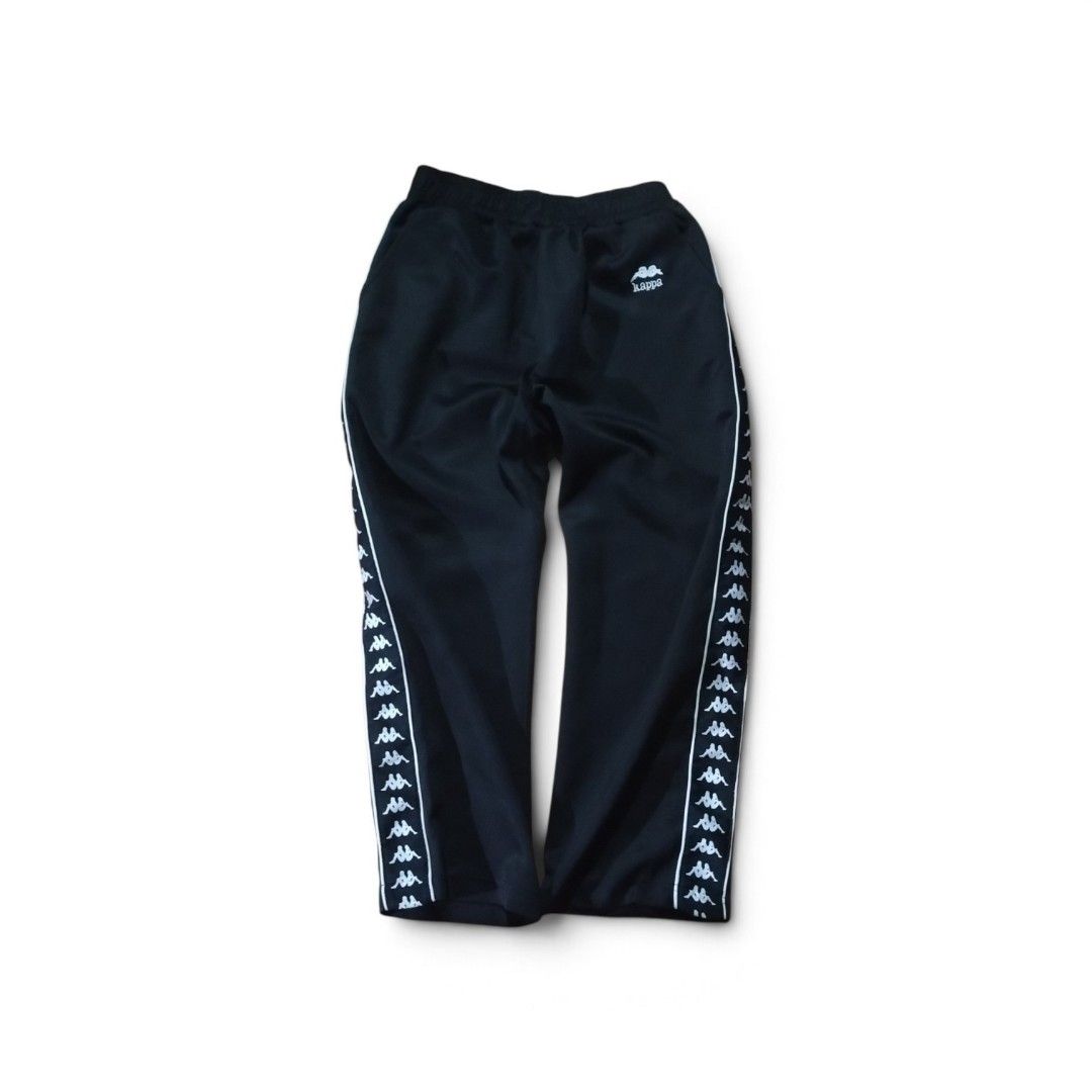 Kappa Black Track Pants with Side Tape (Category: Joggers) located in Tayabas. Submitted by jthriftshop. (Listing ID 1465704417, Image 1). Description: - Color: Classic Black with White Logo Tape - Brand: Kappa (Small embroidered logo on hip) - Fit: Elastic waistband and relaxed leg opening - Material: Lightweight polyester - Condition: Excellent, clean with no stains or snags - Style: Perfect for streetwear or casual lounging.