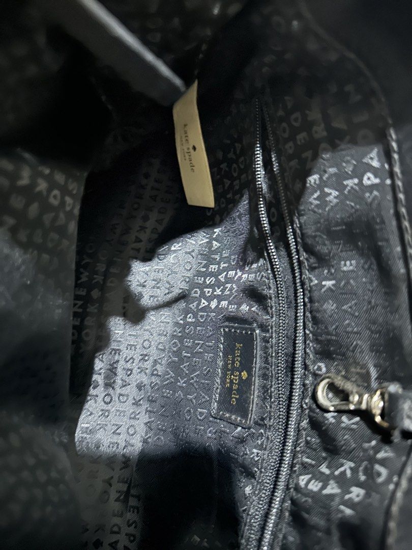 Kate Spade Black Nylon Tote Handbag (Category: Tote Bags) located in Quezon City. Submitted by cassie.u (Listing ID 1465642946, Image 3). Description: - Brand: Kate Spade New York - Material: Durable black nylon with textured leather double handles - Hardware: Elegant gold-tone hardware and signature front plaque - Interior: Fully lined with logo jacquard fabric, featuring a center zip compartment and side slip pockets - Condition: Lightly used N
