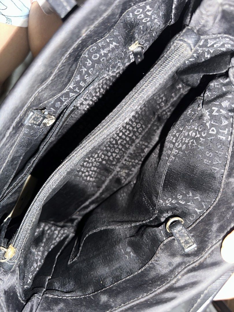 Kate Spade Black Nylon Tote Handbag (Category: Tote Bags) located in Quezon City. Submitted by cassie.u (Listing ID 1465642946, Image 2). Description: - Brand: Kate Spade New York - Material: Durable black nylon with textured leather double handles - Hardware: Elegant gold-tone hardware and signature front plaque - Interior: Fully lined with logo jacquard fabric, featuring a center zip compartment and side slip pockets - Condition: Lightly used N