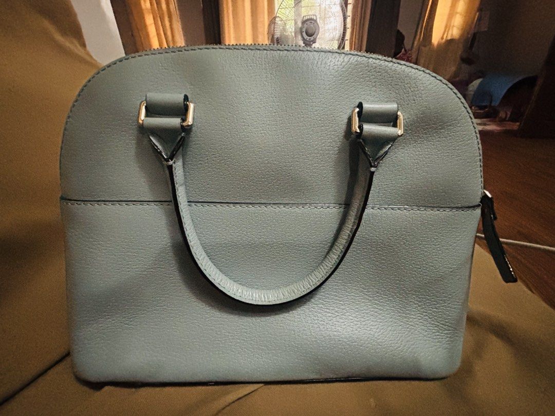 Kate Spade Light Blue Dome Satchel Handbag (Category: Tote Bags) located in Marikina City. Submitted by tracykrystlem (Listing ID 1465607173, Image 3). Description: - Brand: Kate Spade - Style: Dome Satchel - Material: Premium pebbled leather in a charming light blue shade - Hardware: Silver-toned accents - Closure: Top zip closure - Handles: Twin grab handles for easy carrying - Pockets: Convenient exterior slip pocket - Interior: Clean, spaciou