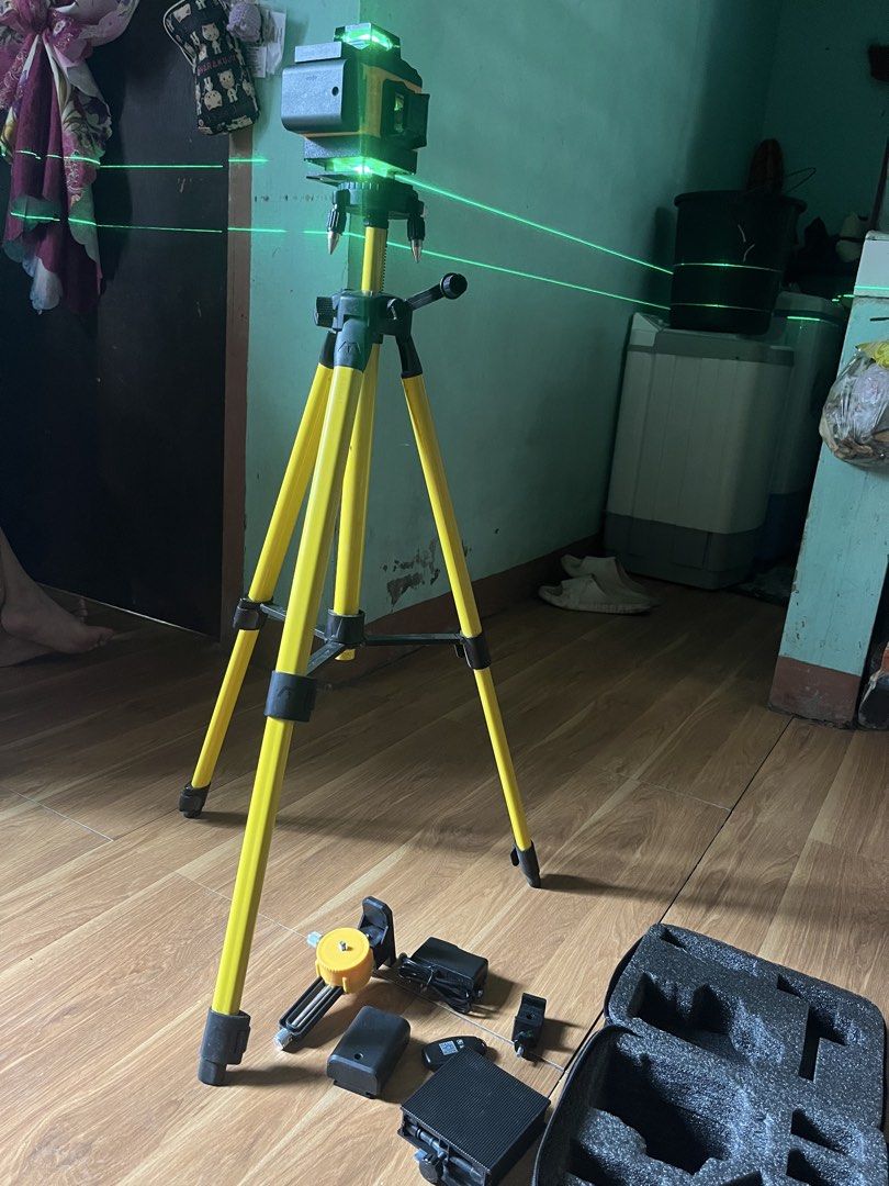Keelat Green Beam Laser Level with Tripod Set (Category: Construction Tools & Equipment) located in Manila. Submitted by shanaaa.collects (Listing ID 1465624075, Image 1). Description: - Brand: Keelat - Type: Green laser level kit - Condition: Fully operational and ready for use - Includes bright green laser lines for leveling and alignment - Yellow adjustable tripod included - Wall mount bracket included - Rechargeable battery and power adapter 