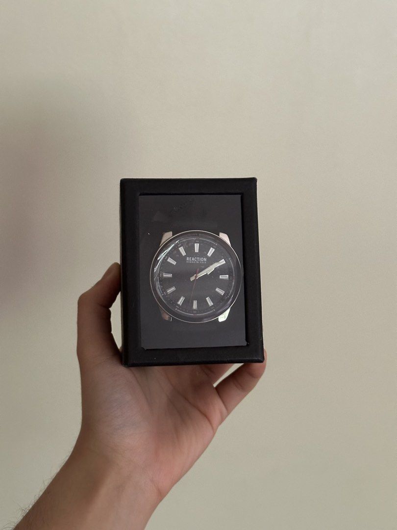 Kenneth Cole Reaction Black Dial Watch with Box (Category: Men's Watches) located in Manila. Submitted by elichhh (Listing ID 1465605262, Image 1). Description: - Brand: Kenneth Cole Reaction - Condition: Brand new, never worn, pristine condition - Dial: Round black dial with silver hour markers and a striking red second hand - Strap: Comfortable black silicone strap with secure buckle closure - Packaging: Comes complete with original branded box