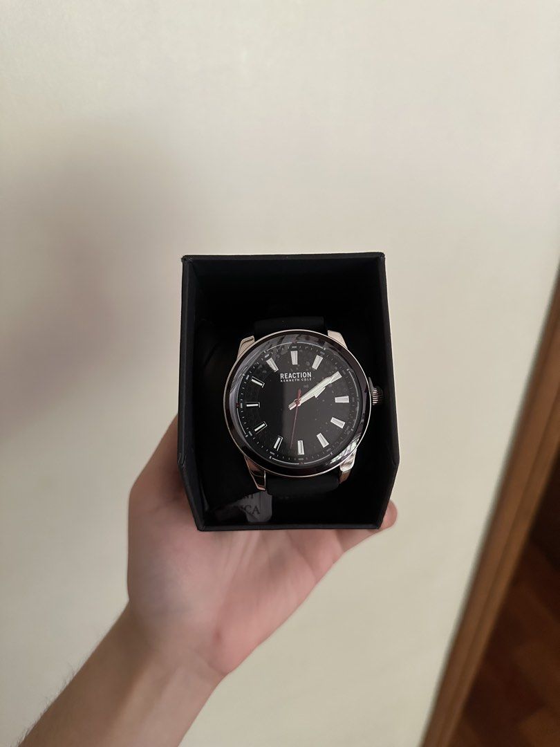 Kenneth Cole Reaction Black Dial Watch with Box (Category: Men's Watches) located in Manila. Submitted by elichhh (Listing ID 1465605262, Image 3). Description: - Brand: Kenneth Cole Reaction - Condition: Brand new, never worn, pristine condition - Dial: Round black dial with silver hour markers and a striking red second hand - Strap: Comfortable black silicone strap with secure buckle closure - Packaging: Comes complete with original branded box