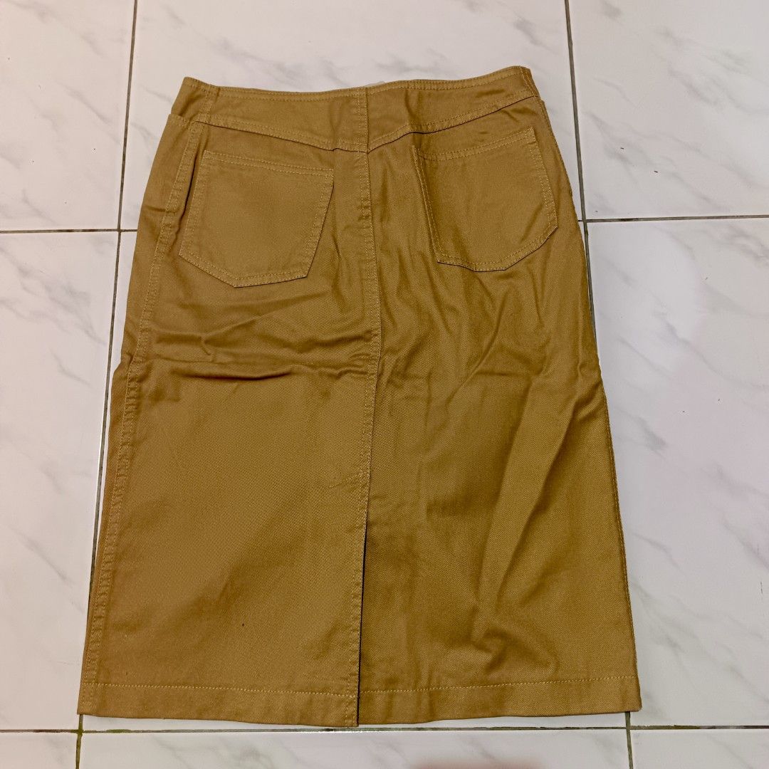 Tan Midi Straight-cut Skirt (Category: Skirts) located in Mangaldan. Submitted by toloveandtofold (Listing ID 1465600975, Image 2). Description: - Brand: Kenneth Cole Reaction - Size: 2 - Color: Warm mustard-brown / tan - Condition: Lock and button needs to be sewn - Waist: 27 inches - Length: 23 inches.