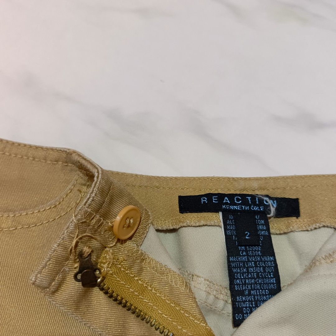 Tan Midi Straight-cut Skirt (Category: Skirts) located in Mangaldan. Submitted by toloveandtofold (Listing ID 1465600975, Image 3). Description: - Brand: Kenneth Cole Reaction - Size: 2 - Color: Warm mustard-brown / tan - Condition: Lock and button needs to be sewn - Waist: 27 inches - Length: 23 inches.