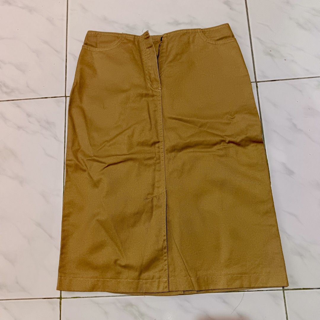 Tan Midi Straight-cut Skirt (Category: Skirts) located in Mangaldan. Submitted by toloveandtofold (Listing ID 1465600975, Image 1). Description: - Brand: Kenneth Cole Reaction - Size: 2 - Color: Warm mustard-brown / tan - Condition: Lock and button needs to be sewn - Waist: 27 inches - Length: 23 inches.