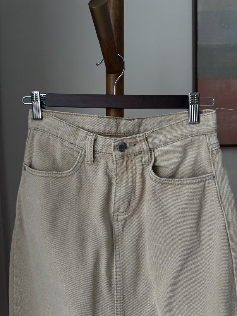 Khaki Denim Midi Skirt with Raw Hem (Category: Skirts) located in Pasig City. Submitted by kutleyn (Listing ID 1465697232, Image 2). Description: - Color: Versatile khaki beige - Style: Classic five-pocket styling with front button closure - Fit: Flattering straight cut midi silhouette - Details: Trendy raw frayed fringe hem and solid front center seam stitching - Material: Durable denim perfect for pairing with tees or sweaters.