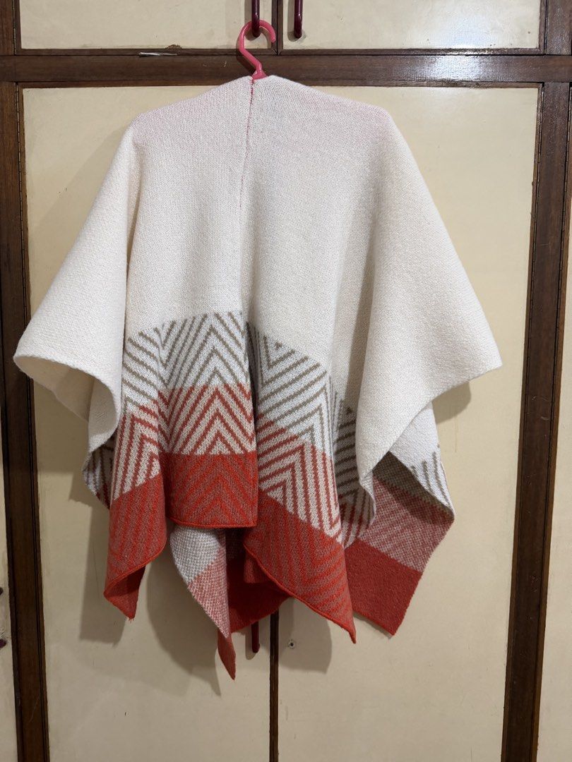 Knit poncho white orange chevron pattern winter cape shawl (Category: Coats, Jackets and Outerwear) located in Manila. Submitted by preloved_new_forsale (Listing ID 1465639670, Image 2). Description: - Color: Cream white with tan and burnt orange chevron hem - Style: Open-front cozy knit poncho - Material: Soft, warm, and textured knit - Size: Free size (fits most body types) - Perfect for: Easy layering on chilly days and autumn evenings.