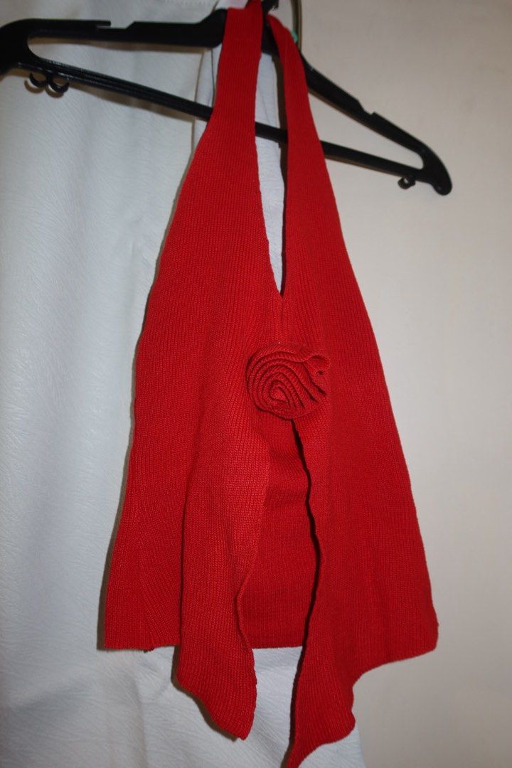 Korean Style Red Rose Halter Top (Category: Sleeveless) located in Cavite. Submitted by mcjkim (Listing ID 1465703598, Image 1). Description: - Color: Vibrant Red - Style: Knitted halter top with trendy 3D front rose accent and split hem - Material: Lightweight, breathable ribbed fabric - Versatility: Perfect for casual days, dates, or beach trips - Pairing: Looks great with high-waisted jeans or a long skirt - Condition: Like new, worn once.