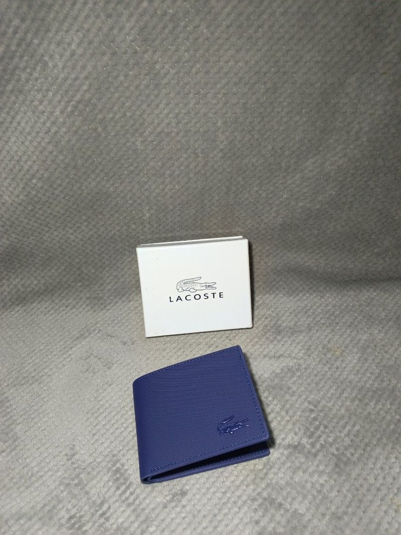 Lacoste Bifold Wallet (Category: Wallets & Card Holders) located in Cebu City. Submitted by authenticgrids (Listing ID 1465723694, Image 2). Description: LACOSTE WALLET 🐊 ‼️I want to resell this brand-new items of mine, never been used I just have another one. Just bought it from a friend abroad Clean navy color with a subtle tonal croc logo. Minimalist design Condition: Brand-new Never Used Color: Navy Blue Comes with box 📦 Perfect everyday wa