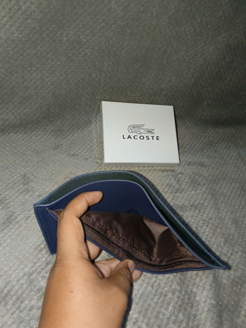 Lacoste Bifold Wallet (Category: Wallets & Card Holders) located in Cebu City. Submitted by authenticgrids (Listing ID 1465723694, Image 3). Description: LACOSTE WALLET 🐊 ‼️I want to resell this brand-new items of mine, never been used I just have another one. Just bought it from a friend abroad Clean navy color with a subtle tonal croc logo. Minimalist design Condition: Brand-new Never Used Color: Navy Blue Comes with box 📦 Perfect everyday wa