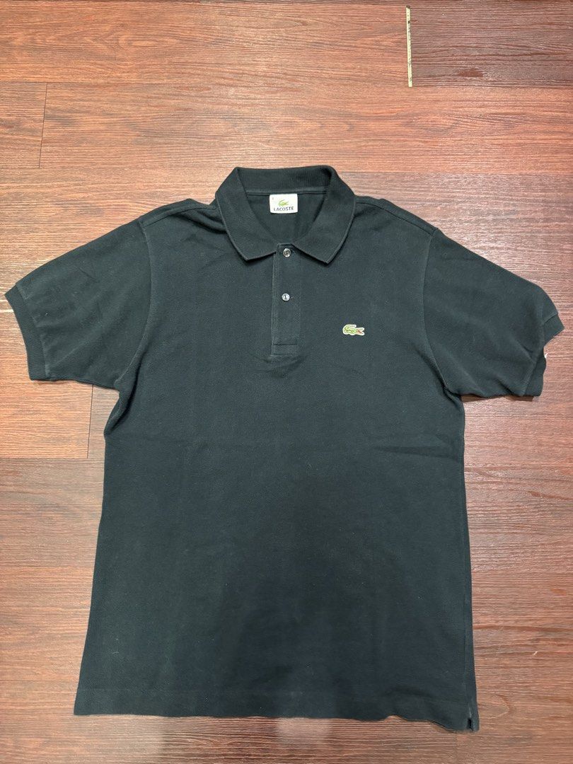 Lacoste Black Polo Shirt (Category: Tshirts & Polo Shirts ) located in Manila. Submitted by douglassss24 (Listing ID 1465579741, Image 1). Description: - Brand: Lacoste - Color: Classic Black - Size: 3 (Regular Fit) - Design: Two-button placket with standard collar - Details: Ribbed armbands and iconic embroidered green crocodile logo on the chest - Condition: Excellent everyday staple piece.