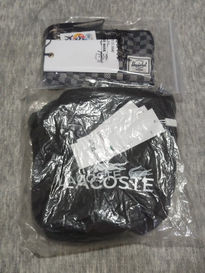 Lacoste Crossbody Bag and Herschel Pouch Bundle (Category: Cross-body Bags) located in Quezon City. Submitted by thirdeedimesiv (Listing ID 1465694969, Image 2). Description: - Brand: Lacoste & Herschel - Condition: Brand new with original tags, sealed in clear plastic - Lacoste Crossbody Bag: Sleek black design with a prominent white front logo and an adjustable black strap - Herschel Pouch: Stylish black-and-white checkered pattern, secure zipp