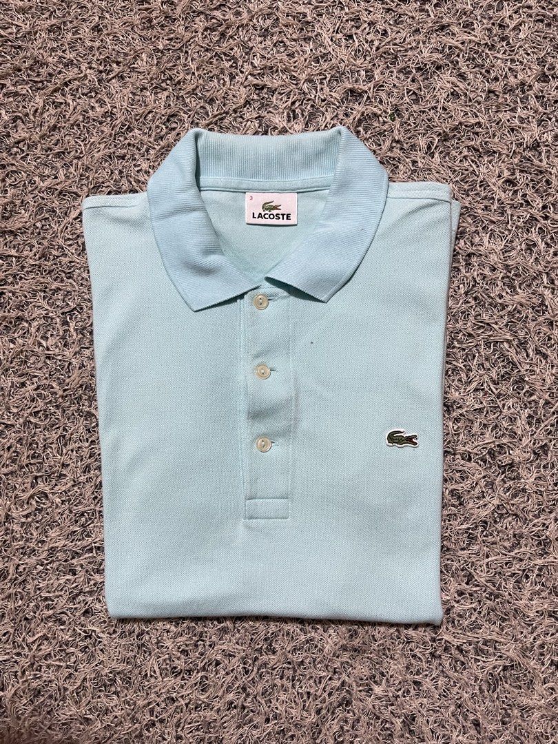 Lacoste Light Blue Polo Shirt Size 3 (Category: Tshirts & Polo Shirts ) located in Palompon. Submitted by keenbird.431209 (Listing ID 1465591986, Image 1). Description: - Authentic Lacoste polo shirt in a versatile light blue shade - Size 3 (printed on inner collar tag) - Comfortable cotton blend fabric - Classic collar with a three-button pearlescent placket - Short sleeves with ribbed cuffs - Signature embroidered green crocodile logo on the le