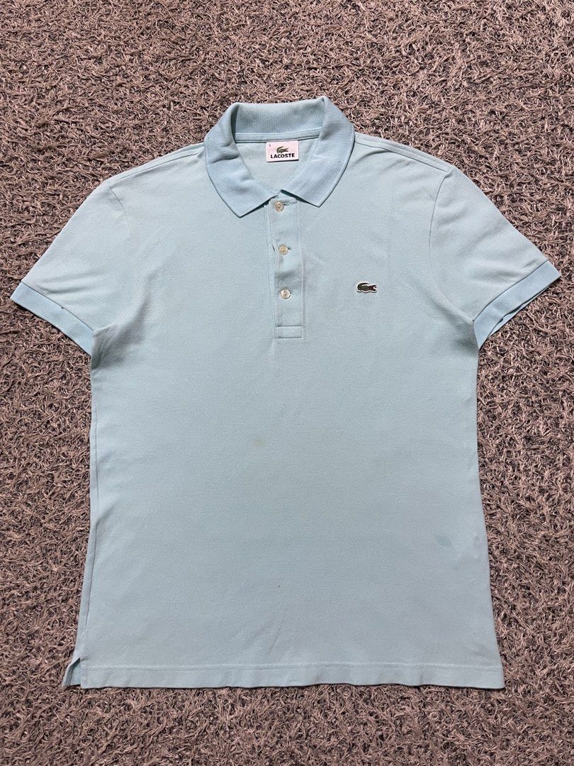 Lacoste Light Blue Polo Shirt Size 3 (Category: Tshirts & Polo Shirts ) located in Palompon. Submitted by keenbird.431209 (Listing ID 1465591986, Image 2). Description: - Authentic Lacoste polo shirt in a versatile light blue shade - Size 3 (printed on inner collar tag) - Comfortable cotton blend fabric - Classic collar with a three-button pearlescent placket - Short sleeves with ribbed cuffs - Signature embroidered green crocodile logo on the le
