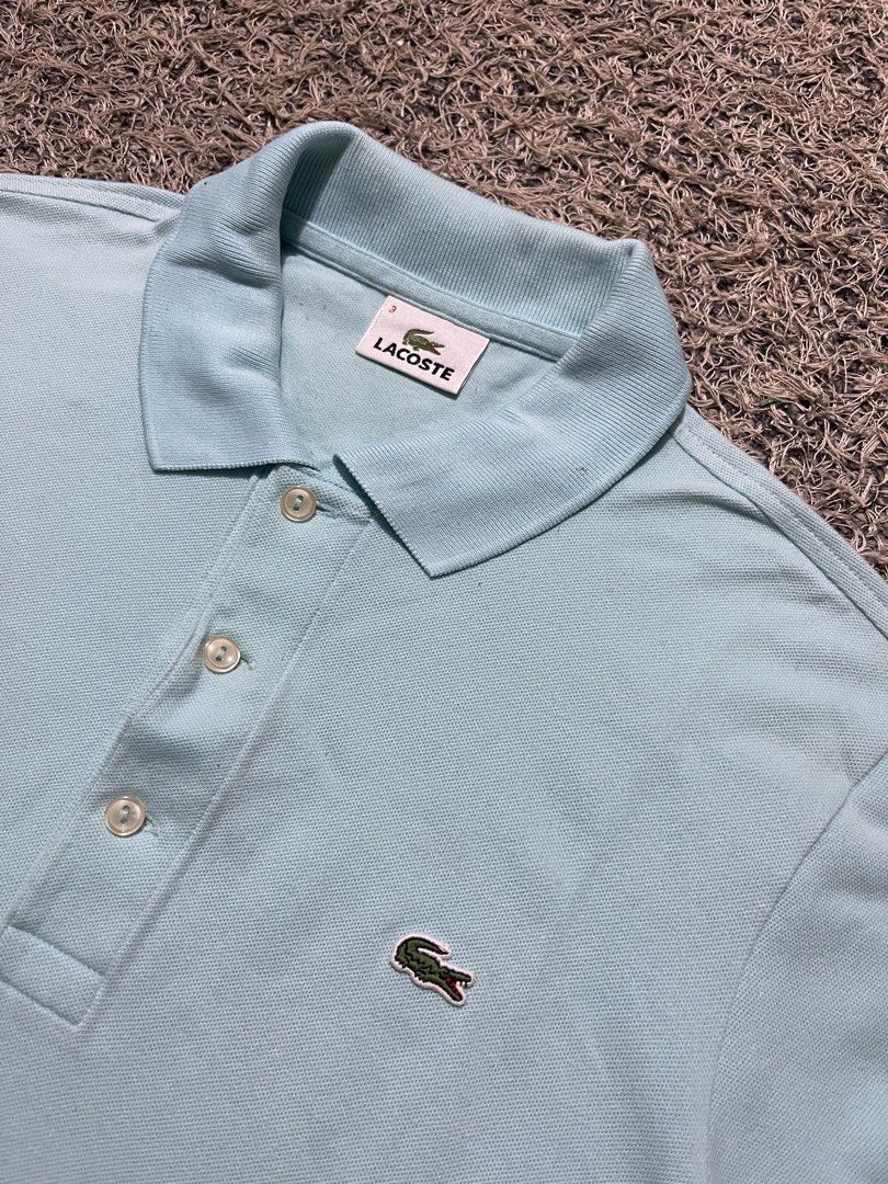 Lacoste Light Blue Polo Shirt Size 3 (Category: Tshirts & Polo Shirts ) located in Palompon. Submitted by keenbird.431209 (Listing ID 1465591986, Image 3). Description: - Authentic Lacoste polo shirt in a versatile light blue shade - Size 3 (printed on inner collar tag) - Comfortable cotton blend fabric - Classic collar with a three-button pearlescent placket - Short sleeves with ribbed cuffs - Signature embroidered green crocodile logo on the le