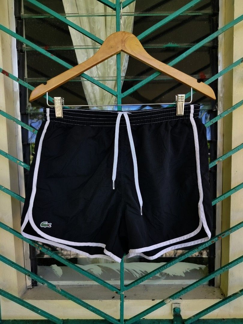 Lacoste Live Black Shorts Size 3 (Category: Shorts) located in Manila. Submitted by virgiliosa38485 (Listing ID 1465705087, Image 1). Description: - Brand: Lacoste Live - Color: Black with white trim - Size: Tagged Size 3 -Waist 28-34 - Waistband: Elastic with adjustable white drawstring and branded aglets - Logo: Small embroidered crocodile on the bottom left hem - Pocket: Single back pocket with white trim and button closure - Material: Lightwe